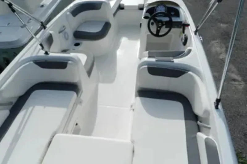 Slide: The Image of 2026 Bayliner Element E18 boat interior with seating and steering wheel. - 14