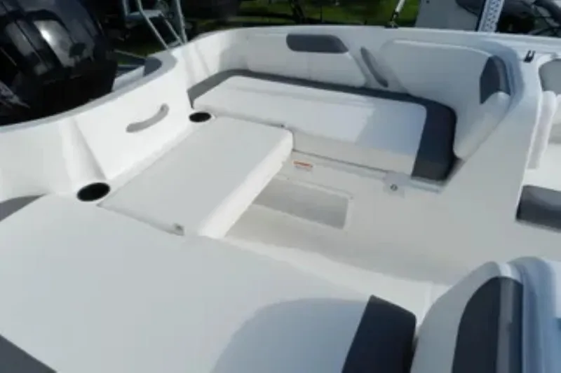 Slide: The Image of 2026 Bayliner Element E18 boat interior with white and gray seating. - 15