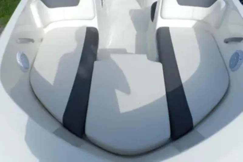 Slide: The Image of 2026 Bayliner Element E18 boat interior seating, featuring white and gray cushioned seats. - 4