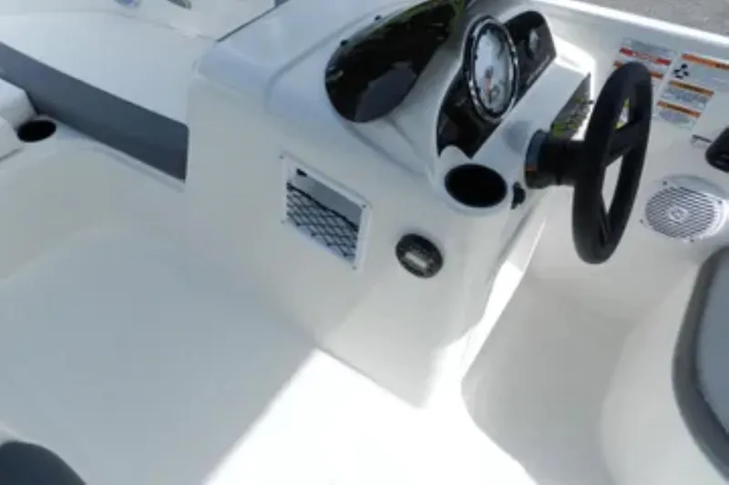 Slide: The Image of 2026 Bayliner Element E18 boat dashboard with steering wheel and controls. - 8