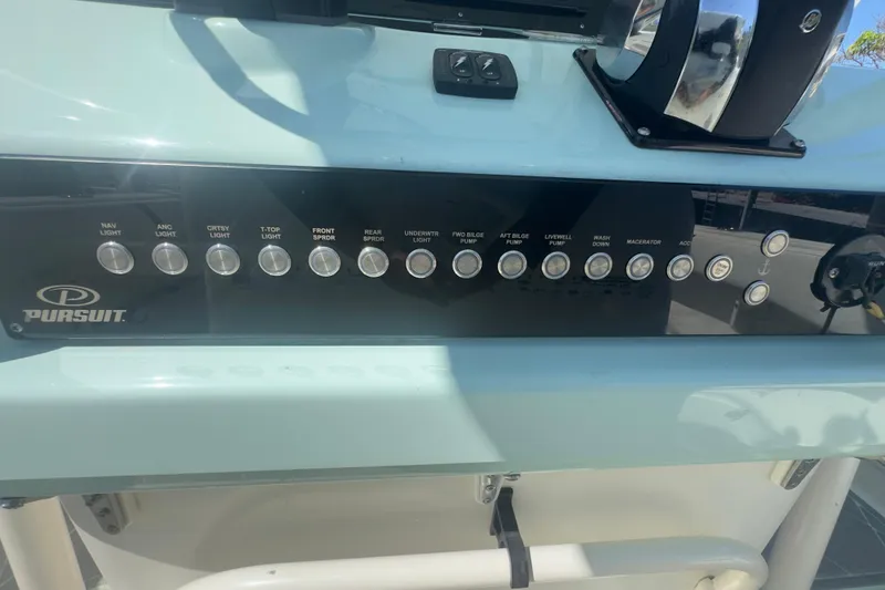 Slide: The Image of Control panel of a 2000 Pursuit 2870 Center Console boat with labeled switches. - 11