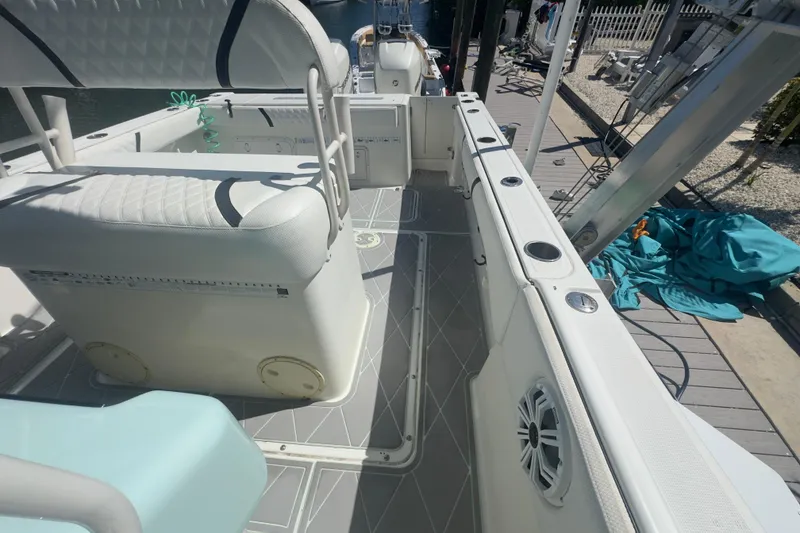Slide: The Image of 2000 Pursuit 2870 Center Console boat interior with seating and rod holders. - 15