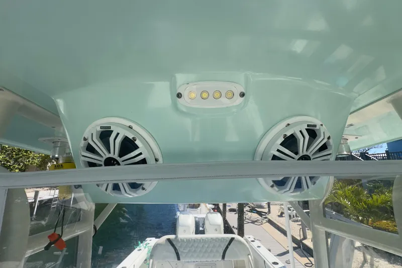 Slide: The Image of 2000 Pursuit 2870 Center Console boat speakers and lights under canopy. - 18