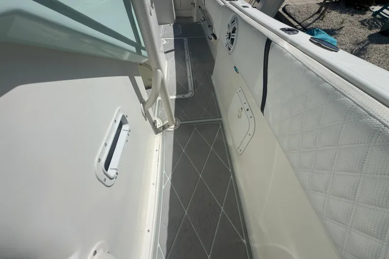 Slide: The Image of 2000 Pursuit 2870 Center Console boat interior with cushioned seating and sleek flooring. - 19