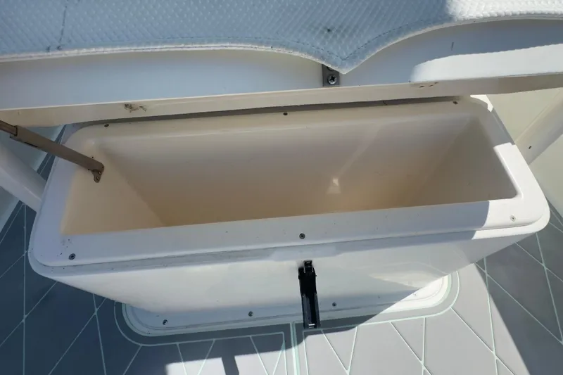 Slide: The Image of Open storage compartment on a 2000 Pursuit 2870 Center Console boat. - 21