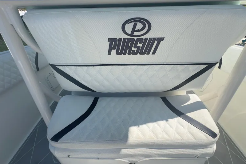 Slide: The Image of Pursuit 2870 Center Console 2000 boat seat with logo, featuring white and black design. - 22