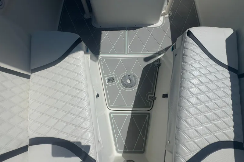 Slide: The Image of Interior view of 2000 Pursuit 2870 Center Console boat with diamond-patterned seating. - 28