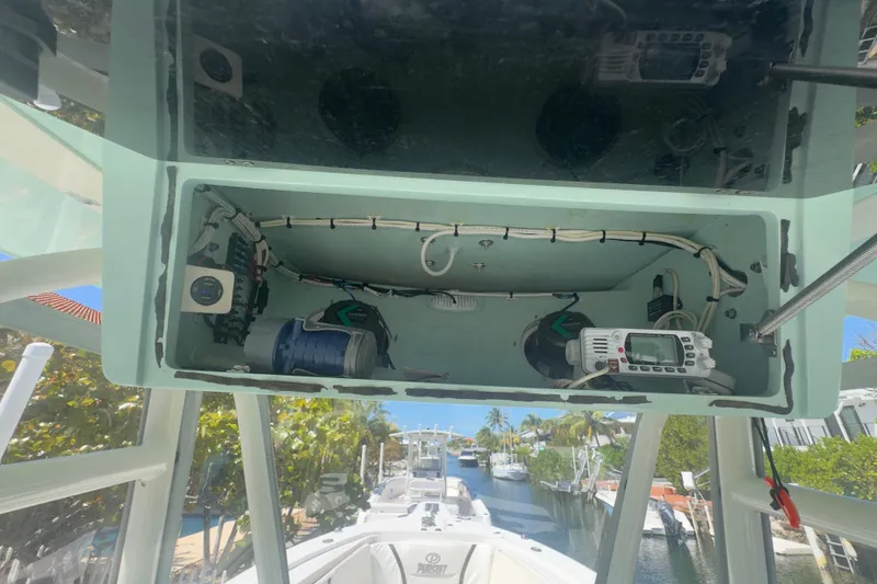 Slide: The Image of 2000 Pursuit 2870 Center Console boat electronics compartment with wiring and devices. - 3
