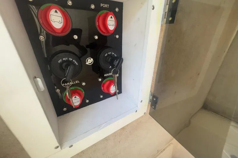 Slide: The Image of Control panel of a 2000 Pursuit 2870 Center Console boat with switches and keys. - 36