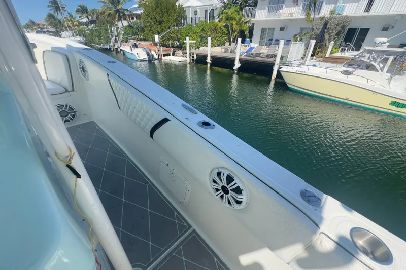 Slide: The Image of 2000 Pursuit 2870 Center Console boat docked by waterfront homes. - 38
