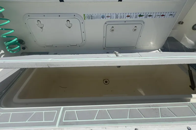 Slide: The Image of Open storage compartment on a 2000 Pursuit 2870 Center Console boat. - 42