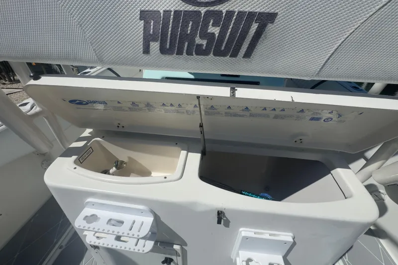 Slide: The Image of 2000 Pursuit 2870 Center Console boat with open storage compartments and sink. - 44