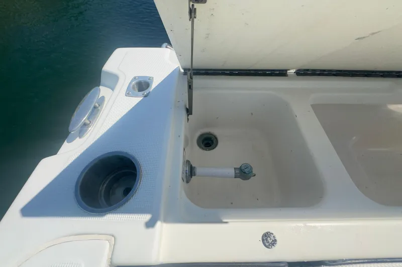 Slide: The Image of 2000 Pursuit 2870 Center Console boat with open storage compartment and cup holder. - 46