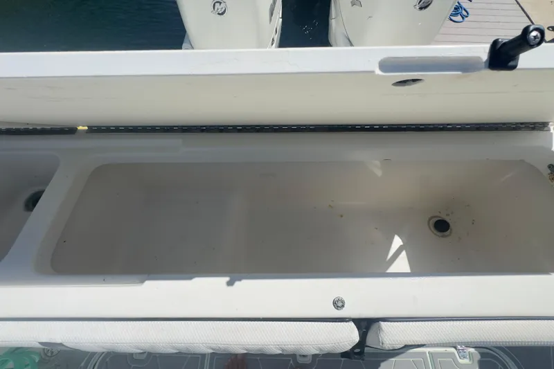 Slide: The Image of Open storage compartment on a 2000 Pursuit 2870 Center Console boat. - 48