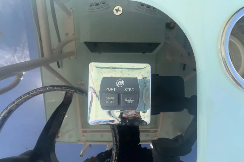 Slide: The Image of Control panel of a 2000 Pursuit 2870 Center Console boat, featuring start/stop buttons. - 9