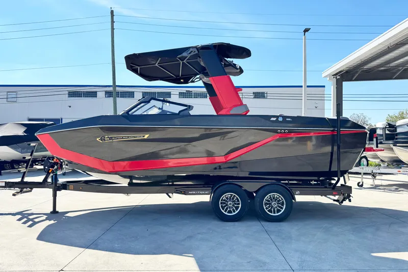 The Image of 2025 Nautique Super Air Nautique G23 Coastal Edition boat on trailer, sleek design. - 1