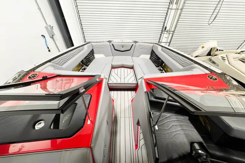 Slide: The Image of 2025 Nautique Super Air Nautique G23 Coastal Edition interior with red accents and sleek design. - 12