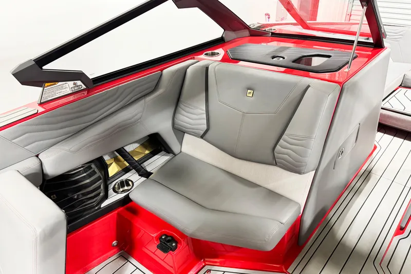 Slide: The Image of 2025 Nautique Super Air Nautique G23 Coastal Edition interior with gray and red seating. - 16