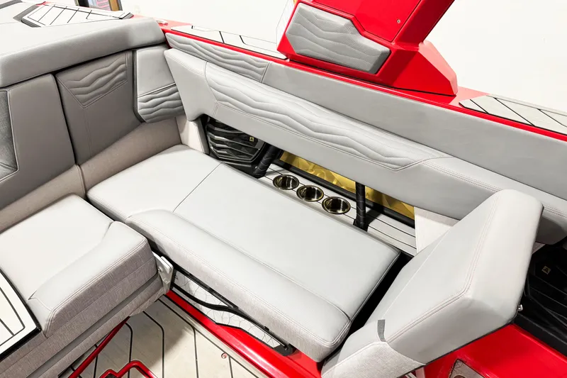 Slide: The Image of 2025 Nautique Super Air Nautique G23 Coastal Edition interior with gray seating and cup holders. - 17