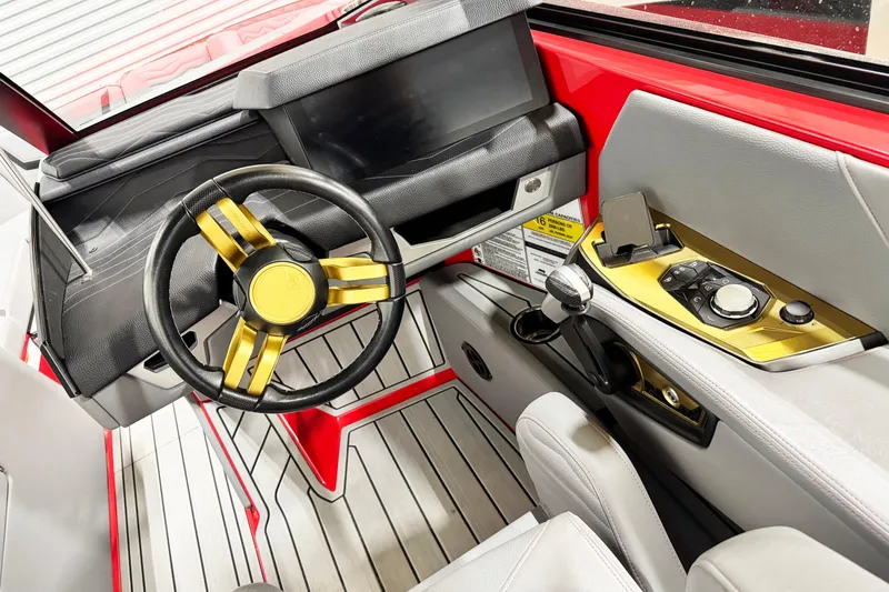 Slide: The Image of 2025 Nautique Super Air Nautique G23 Coastal Edition cockpit with modern steering and controls. - 7