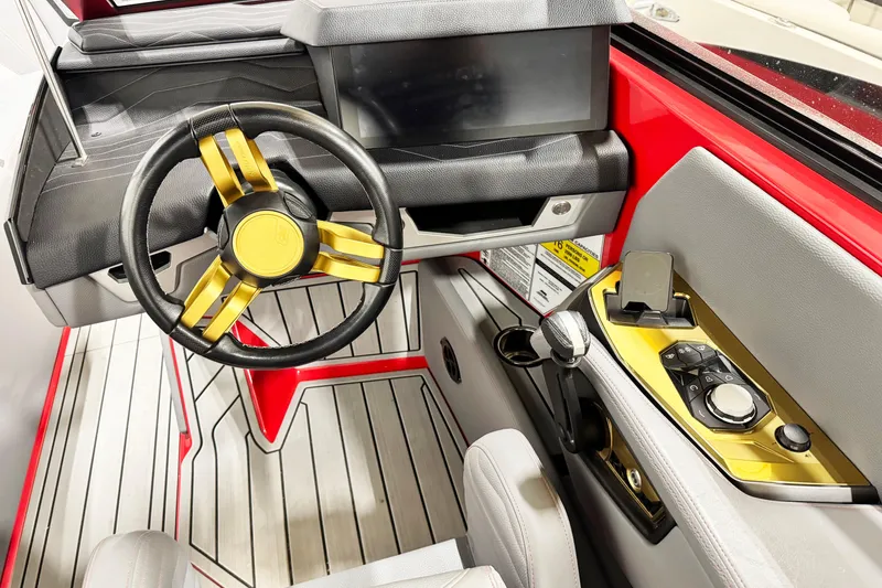 Slide: The Image of 2025 Nautique Super Air Nautique G23 Coastal Edition cockpit with modern steering and controls. - 8