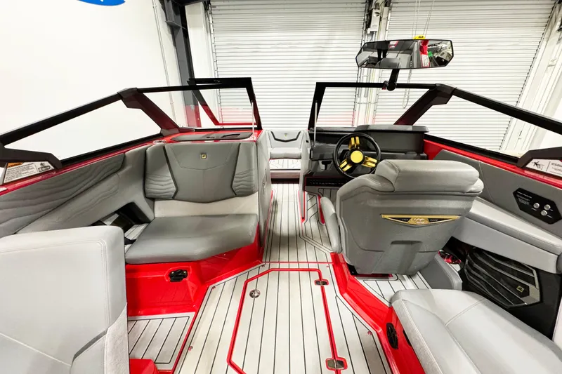 Slide: The Image of 2025 Nautique Super Air Nautique G23 Coastal Edition interior with red accents and modern design. - 9