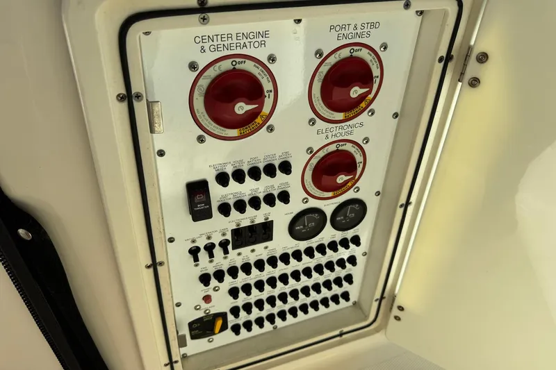 Slide: The Image of Control panel of a 2011 Pursuit OS 375 Offshore boat, featuring engine and electronics switches. - 21