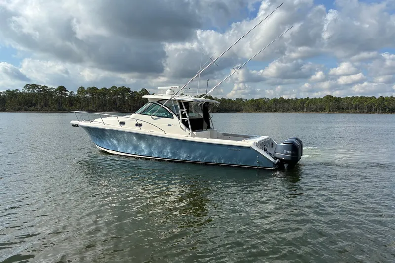 Slide: The Image of 2011 Pursuit OS 375 Offshore boat on calm water under cloudy sky. - 3