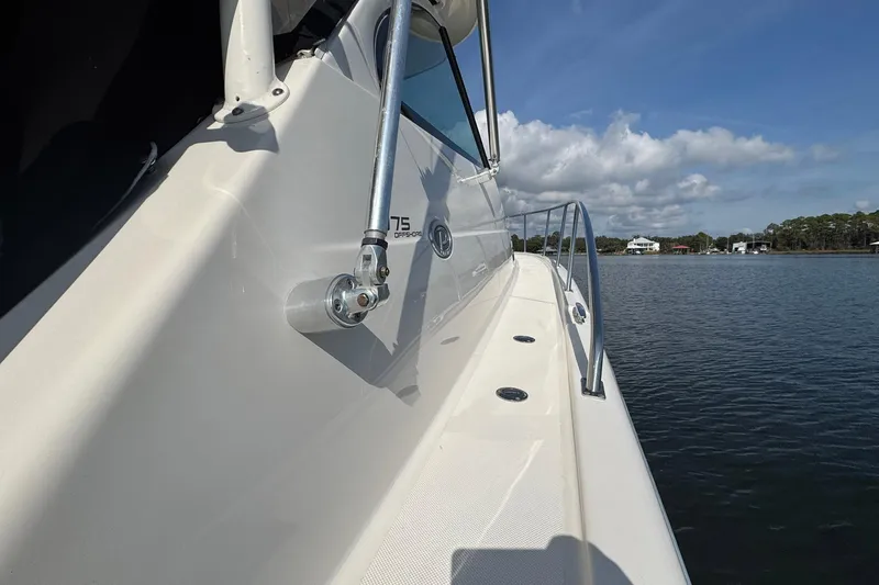 Slide: The Image of 2011 Pursuit OS 375 Offshore boat on calm water under blue sky. - 7