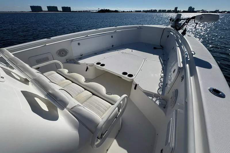 Slide: The Image of 2008 Everglades 350 Center Console boat on calm water, showcasing spacious seating and deck. - 16