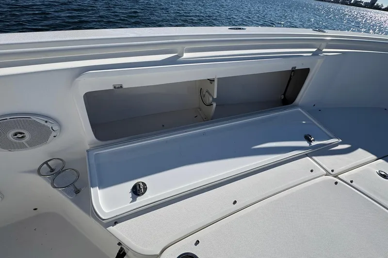 Slide: The Image of 2008 Everglades 350 Center Console boat with open storage compartment on deck. - 17