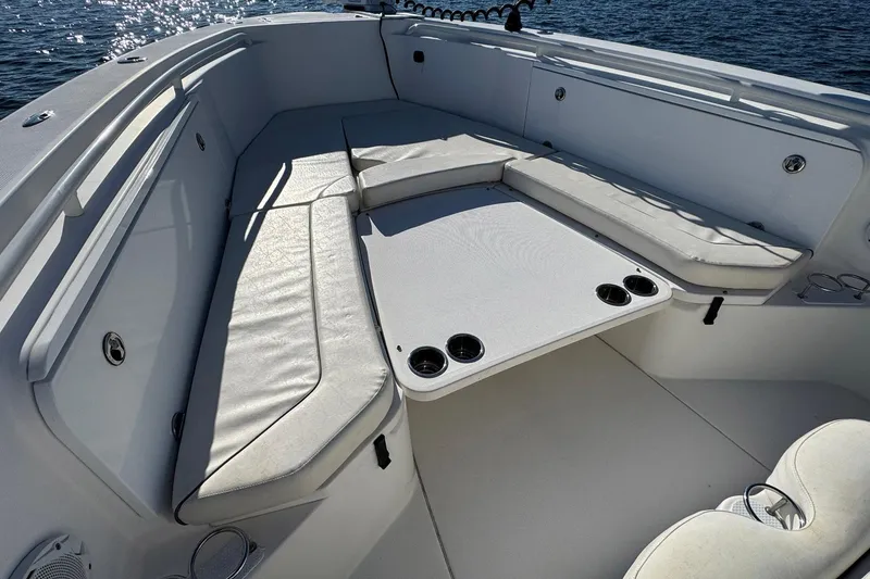 Slide: The Image of 2008 Everglades 350 Center Console boat interior with cushioned seating and table. - 24