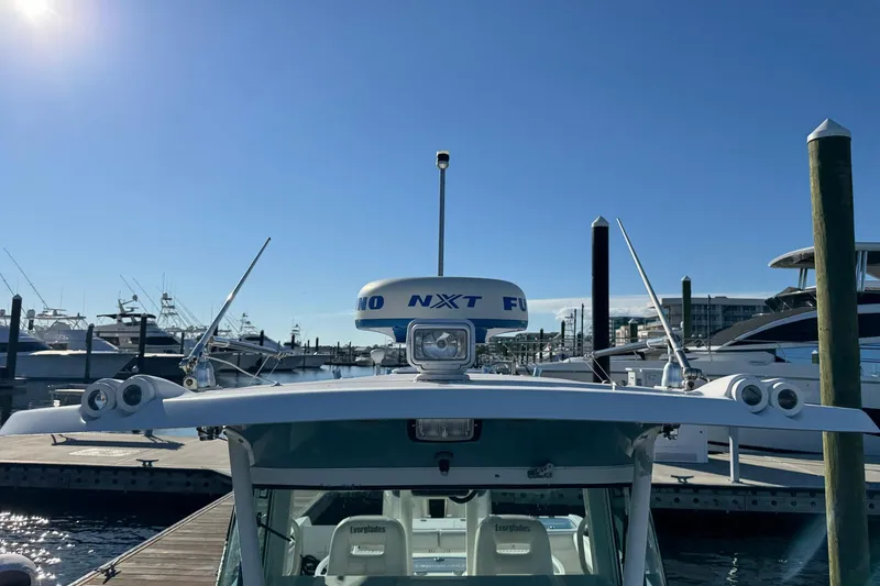Slide: The Image of 2008 Everglades 350 Center Console boat docked under clear blue sky. - 31