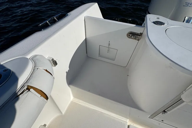 Slide: The Image of 2008 Everglades 350 Center Console boat interior with worn seating and storage compartment. - 36