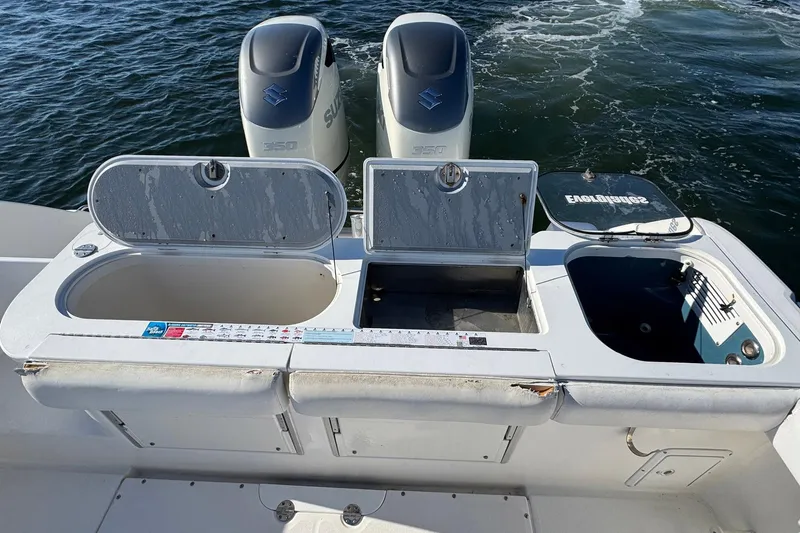 Slide: The Image of 2008 Everglades 350 Center Console boat with open storage compartments and dual Suzuki engines. - 37