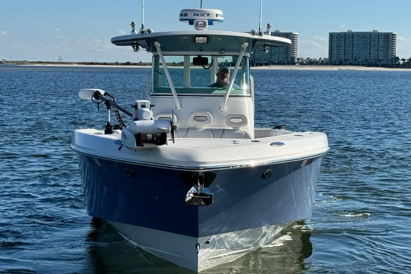 Slide: The Image of 2008 Everglades 350 Center Console boat on water, with cityscape in background. - 6