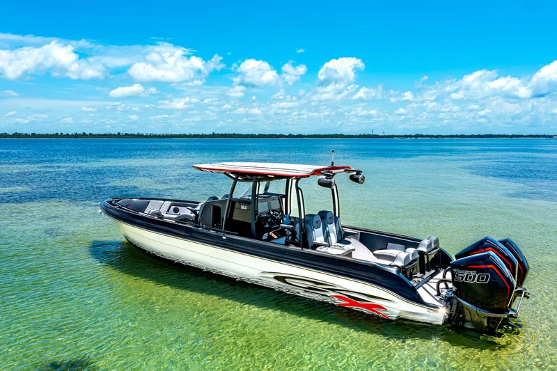 The Image of 2025 Glasstream 36 boat with triple engines on clear blue water under a sunny sky. - 0