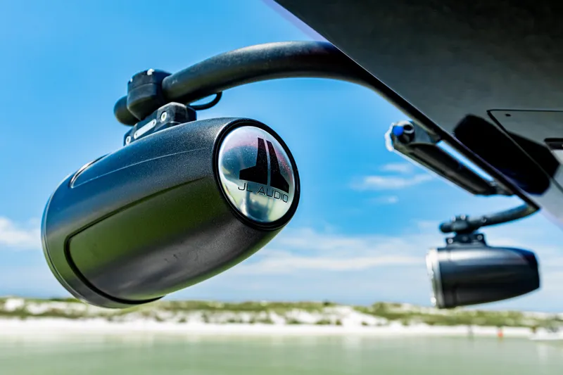 Slide: The Image of JL Audio speakers on a 2025 Glasstream 36 boat, with a clear blue sky background. - 13