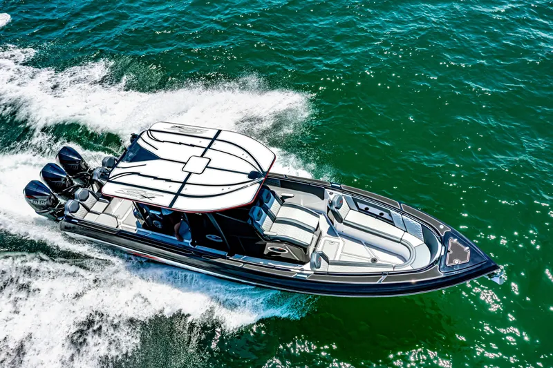 Slide: The Image of 2025 Glasstream 36 boat cruising on vibrant blue water, showcasing sleek design and powerful engines. - 14