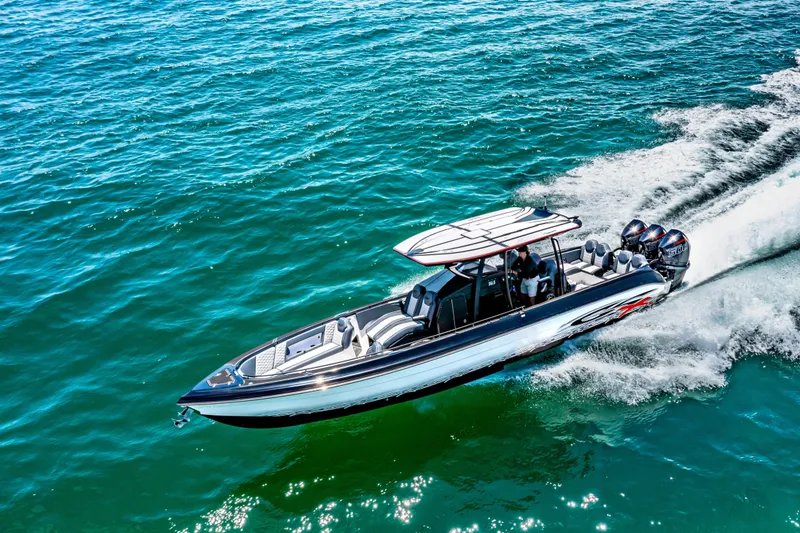 Slide: The Image of 2025 Glasstream 36 boat cruising on clear blue water, showcasing sleek design and powerful engines. - 15