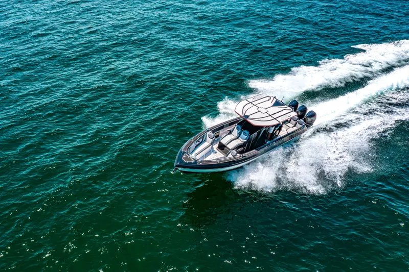 Slide: The Image of 2025 Glasstream 36 boat cruising on open water, creating a dynamic wake. - 16