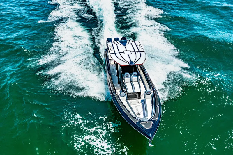 Slide: The Image of 2025 Glasstream 36 boat cruising on open water, creating a dynamic wake. - 17