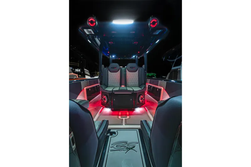 Slide: The Image of 2025 Glasstream 36 boat interior with ambient red lighting and modern seating design. - 20