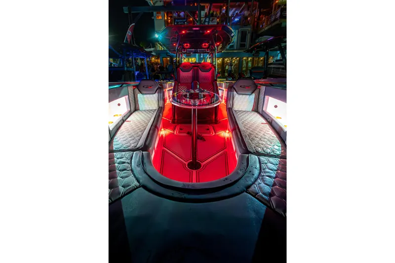 Slide: The Image of Luxurious 2025 Glasstream 36 boat interior with vibrant red lighting and plush seating. - 22