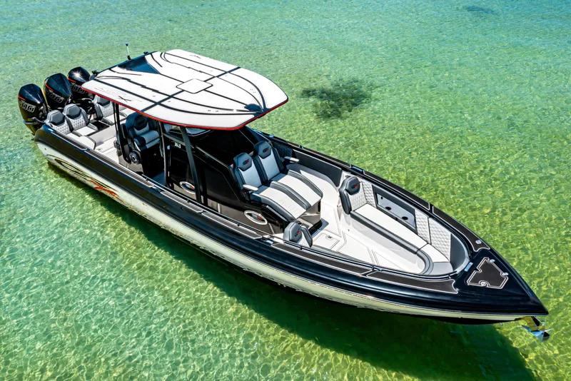 Slide: The Image of 2025 Glasstream 36 boat on clear turquoise water, showcasing sleek design and powerful engines. - 3