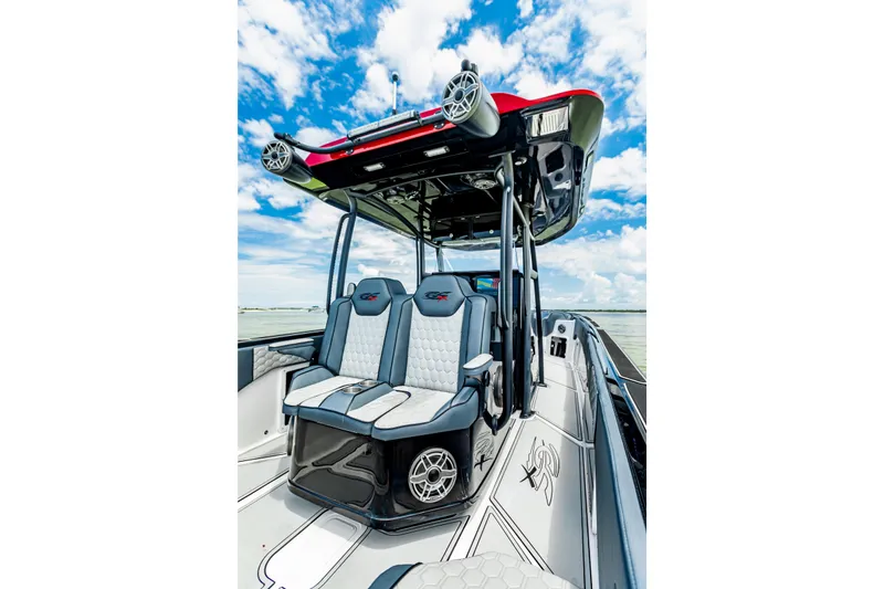 Slide: The Image of 2025 Glasstream 36 boat interior with modern seating and sleek design under a blue sky. - 7