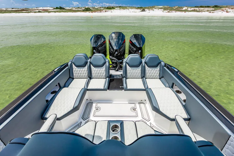 Slide: The Image of 2025 Glasstream 36 boat with luxurious seating and triple engines in clear waters. - 8