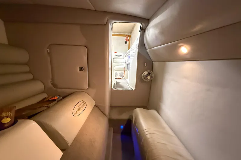 Slide: The Image of Interior of 2004 MTI 44 Pleasure Cat boat, featuring cozy seating and ambient lighting. - 10