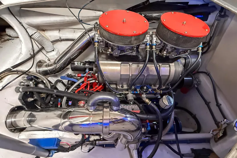 Slide: The Image of Engine compartment of a 2004 MTI 44 Pleasure Cat with dual air filters and chrome components. - 13