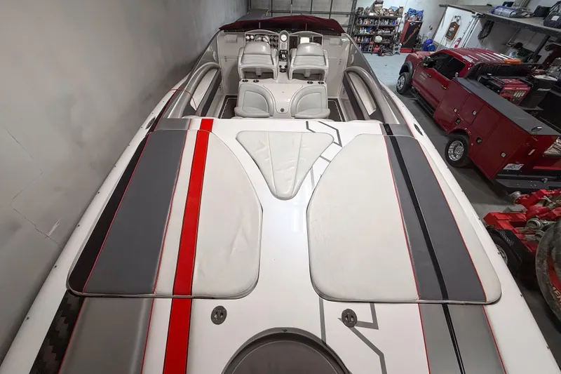 Slide: The Image of 2004 MTI 44 Pleasure Cat boat with sleek design in a garage setting. - 6